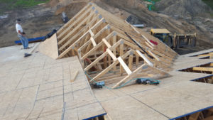 Licensed Custom Quality Renovations contractors building a roof.