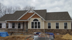 Custom roofing, siding, stonework, and windows by Custom Quality Renovations.