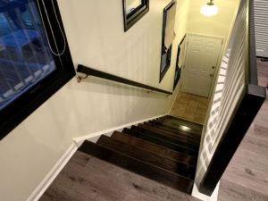 Custom stairs and flooring by Custom Quality Renovations.